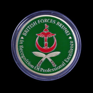 Custom British Forces Brunei challenge coin featuring a vibrant green enamel background, crossed kukri knives and the Brunei Armed Forces crest. Designed to recognise professional excellence and military achievement through a bespoke commemorative coin.
